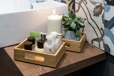 a wooden tray with soap and a candle on a table at Z-ArchSuites in Rome