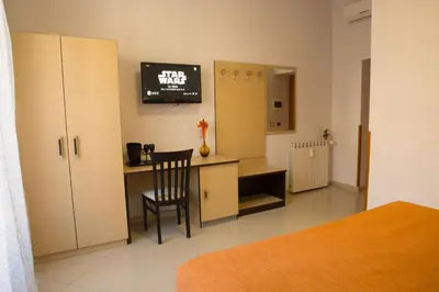 a bedroom with a desk and a chair in a room at All Seasons in Rome
