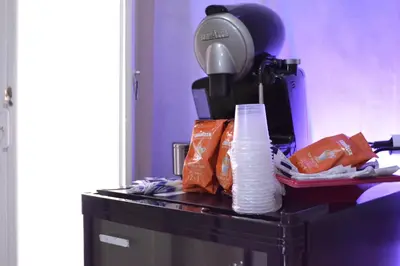 a table with a pile of paper towels and a hair dryer at Tiburtina House in Rome