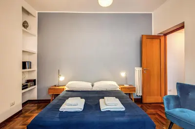 a bedroom with a blue bed and a blue chair at ilPlatano-Testaccio in Rome