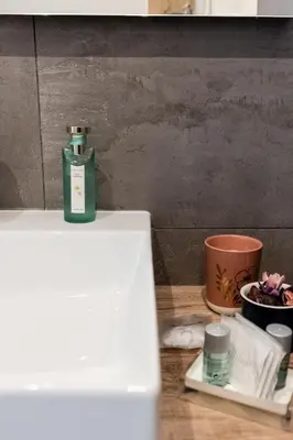 a bottle of soap sitting on top of a counter at Eighty Four Rooms in Rome