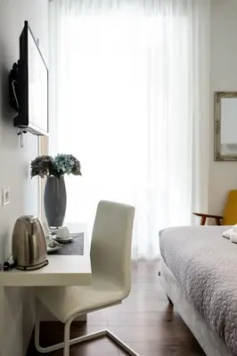 a bedroom with a desk in front of a bed at Eighty Four Rooms in Rome