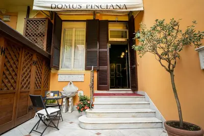 a house with a staircase leading to the front door at Domus Pinciana in Rome