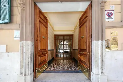 an entrance to a building with two large wooden doors at Tibullo Guesthouse in Rome