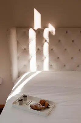 a tray of pastries on a white bed at Imperia Suite in Rome