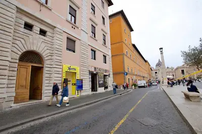 a group of people walking down a city street at St. Peter' Six Rooms & Suites in Rome