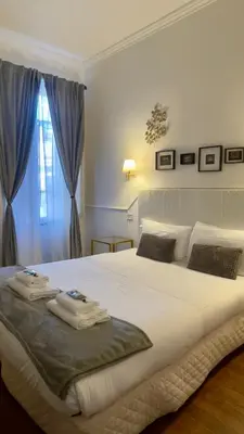 a bedroom with a large white bed with a window at Suitedream Vatican in Rome