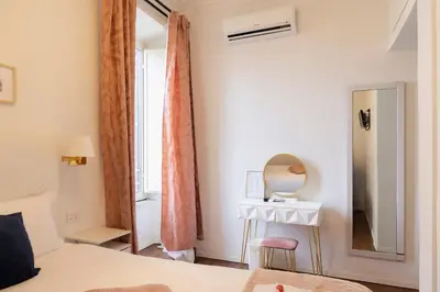 a bedroom with a bed and a mirror and a table at Suitedream Vatican in Rome