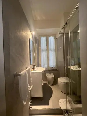 a bathroom with a sink and a tub and a toilet at Suitedream Vatican in Rome