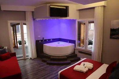 a large bathroom with a tub and a tv at MILLINA SUITES IN NAVONA in Rome