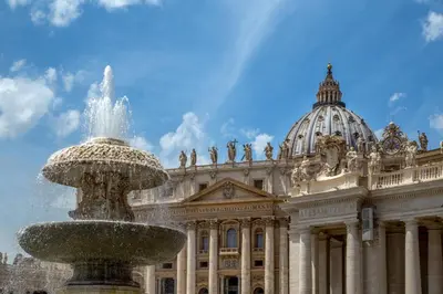 a building with a fountain in front of a building at Borgo Pio Charme in Rome