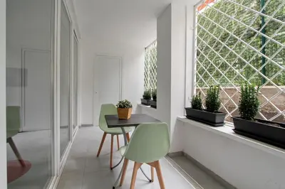 a dining room with a table and chairs and a window at Vatican Loft - Rooms & Apartments in Rome