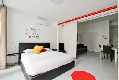 a bedroom with a bed and a dining room at Vatican Loft - Rooms & Apartments in Rome