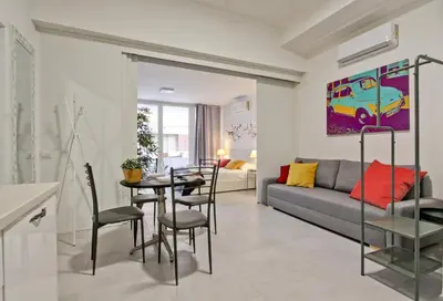 a living room with a table and a couch at Vatican Loft - Rooms & Apartments in Rome