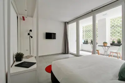 a bedroom with a bed and a table with a laptop at Vatican Loft - Rooms & Apartments in Rome