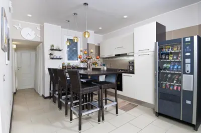 a kitchen with a table and chairs and a refrigerator at Bed & Breakfast Armonie Romane in Rome