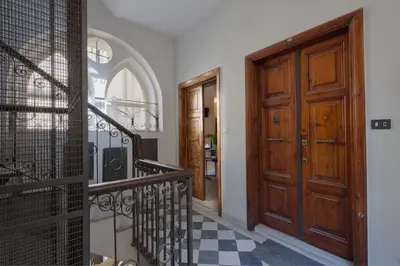 a hallway with a staircase and a wooden door at Suite Horti Sallustiani in Rome