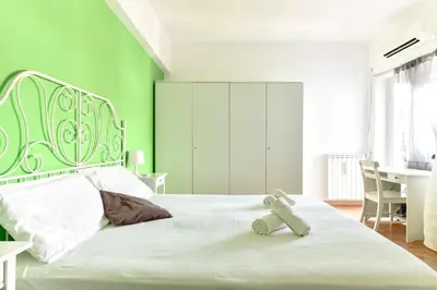 a green bedroom with a bed with a teddy bear on it at La Canterina al Vaticano in Rome