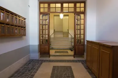 a hallway with doors and stairs in a building at Domus Florea in Rome