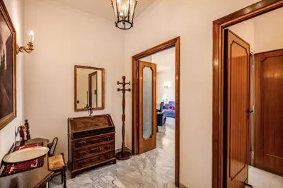 a hallway with a mirror and a dresser in a room at BlueClassicHome in Rome