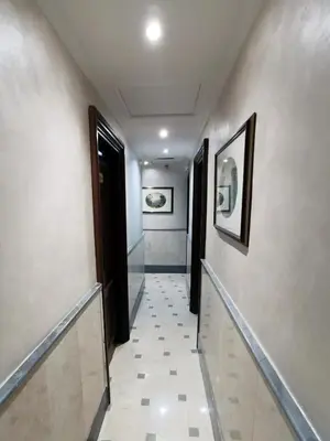 a hallway with two doors and a tile floor at Hotel Valentino Palace in Rome