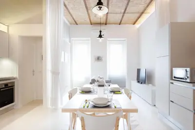 a kitchen with a table and chairs in a room at Lilli Vatican White Domus in Rome