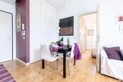 a dining room with a black table and white chairs at Lambertone, cozy flat in Rome, Aurelio Vatican in Rome