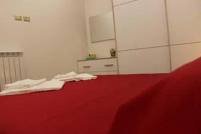 a bedroom with a red bed with towels on it at Locazione Turistica 