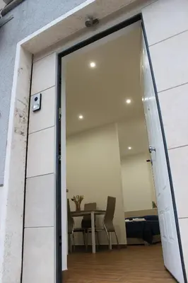 an open door leading into a dining room with a table at Locazione Turistica 