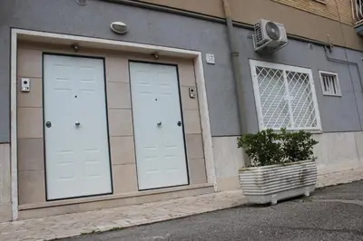 two white doors on the side of a building at Locazione Turistica 