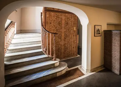 a staircase in a house with a door at Rome As You Feel - Baccina 95 Forum Apartment in Rome