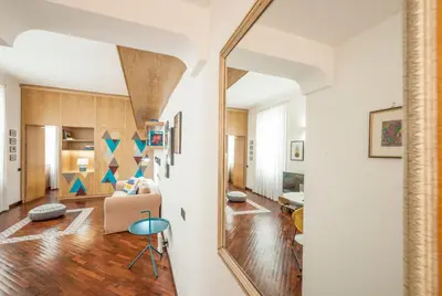 a large mirror in a hallway with a living room at Rome As You Feel - Baccina 95 Forum Apartment in Rome