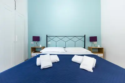 a large blue bed with two white pillows on it at L'Imperiale RomaTrastevere in Rome
