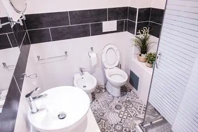 a bathroom with a toilet and a sink at Roma Centrale Fidelis in Rome