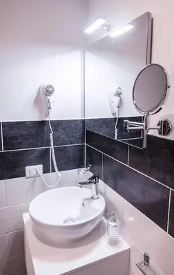 a bathroom with a sink and a mirror at Roma Centrale Fidelis in Rome