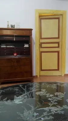 a bedroom with a white bed and a dresser at Via Giulia Apartment in Rome