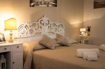 a bedroom with a large white bed with two pillows at House Bonifacio in Rome