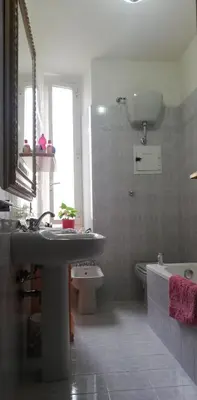 a bathroom with a sink and a toilet and a mirror at La Risorgente B&B in Rome
