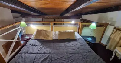 a bedroom with a bed with a pillow on it at Amazing panoramic artist's loft Spanish Steps in Rome