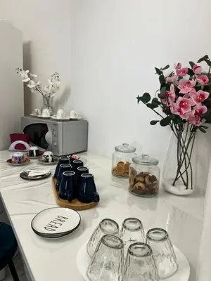 a counter with jars and vases of flowers on it at Guest House Esty in Rome