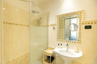 a bedroom with a bed and a large window at Capitolium Rooms in Rome