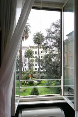 a bedroom with a large white bed with towels on it at Capitolium Rooms in Rome