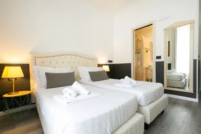 a bedroom with a large bed and a desk at Capitolium Rooms in Rome