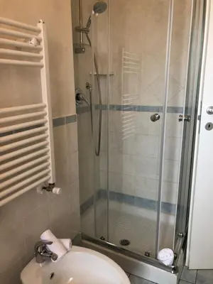 a bathroom with a shower with a toilet and a sink at Isabel in Rome