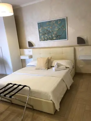 a bedroom with a bed with a painting on the wall at Isabel in Rome