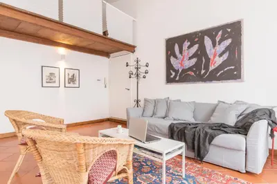 a living room with a couch and a table with a laptop at Monti Stairway to Heaven in Rome