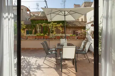 a table and chairs with an umbrella on a patio at Monti Stairway to Heaven in Rome