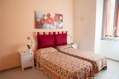 a bedroom with a bed and a painting on the wall at Merulana Suite in Rome