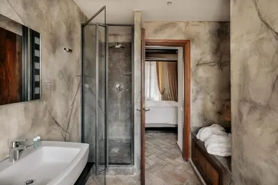 a bathroom with a sink and a glass shower at Relais Giulia in Rome