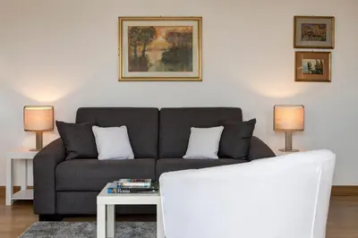 a living room with a couch and two lamps at Le case di Andrea Piccolomini San Peter - Terrace Flat in Rome